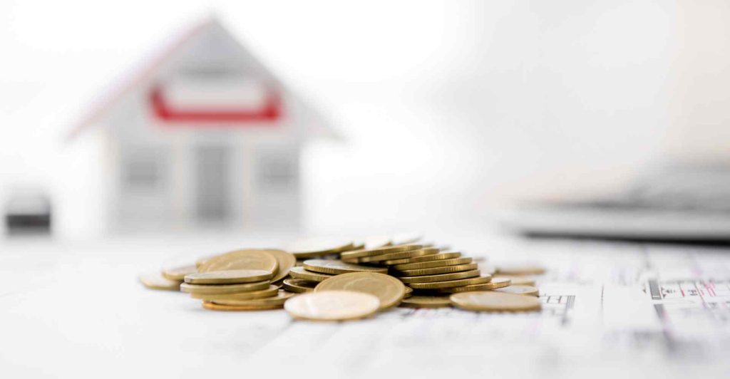 HVAC financing concept - money on blueprint paper with blurred house model in background