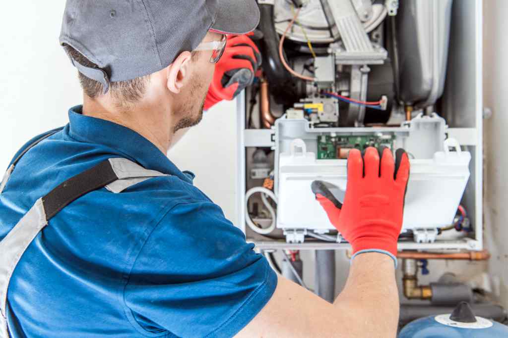 A technician performs furnace installations with residential Heating Gas Furnace equipment.