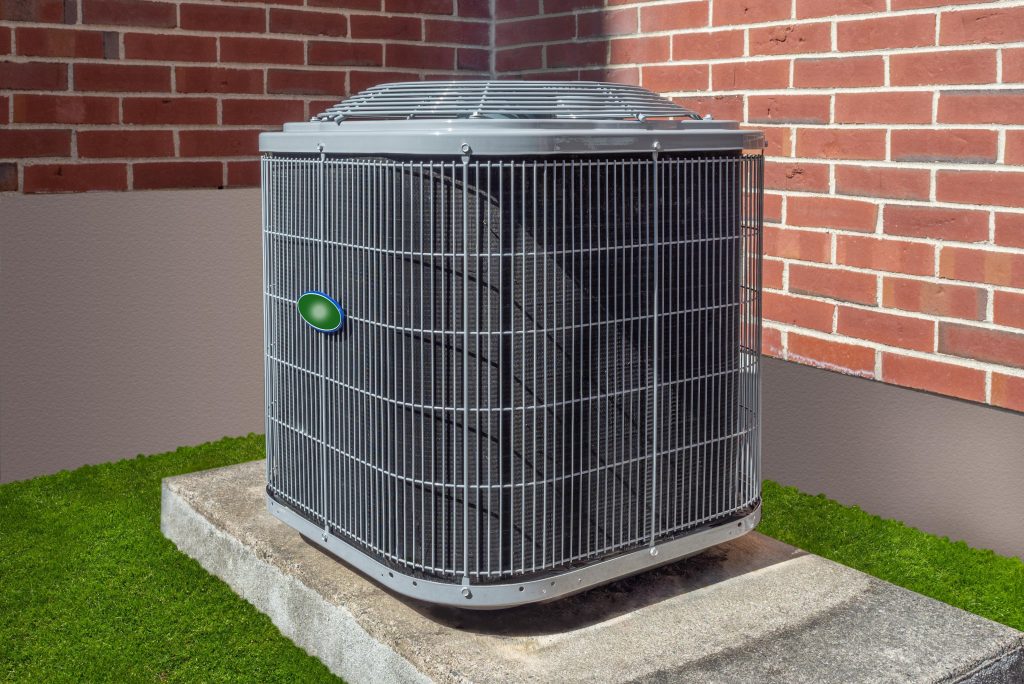 Outdoor air conditioning condenser unit beside a brick home during summer, representing AC running constantly and cooling issues.